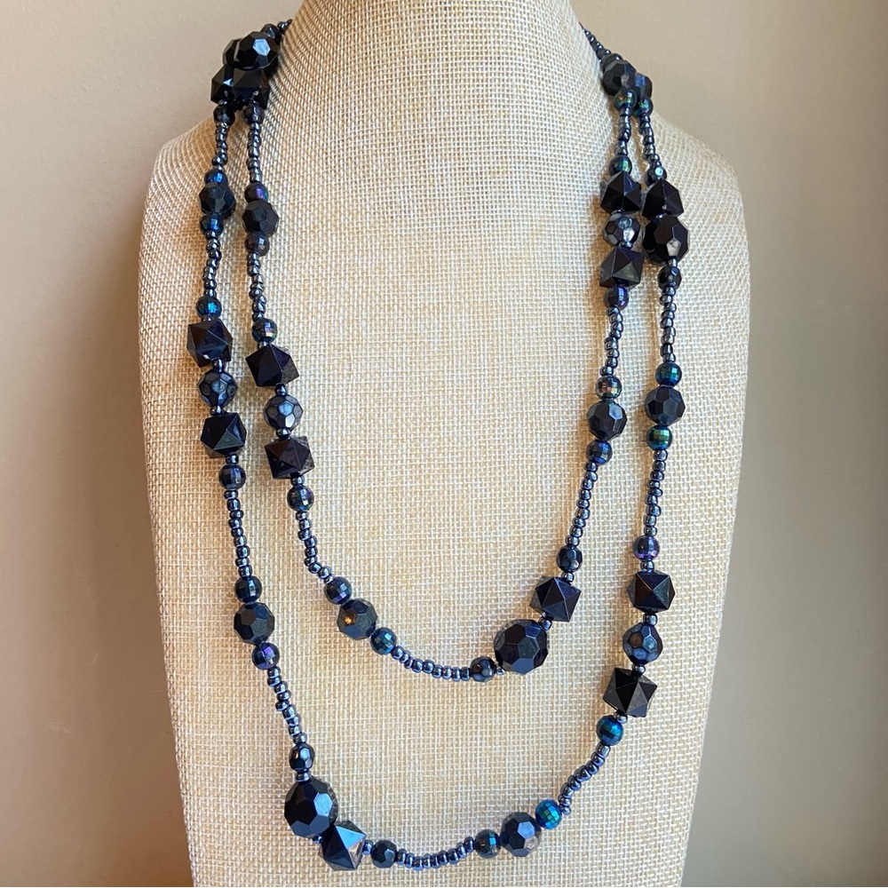 Long single strand beaded necklace in black faceted and iridescent seed beads